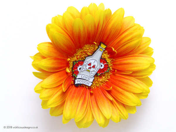 Love Potion & Skull Tattoo Soft Enamel Pin in a Gerbera