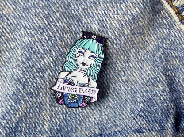 Living Dead Zombie Girl Tattoo Soft Enamel Pin pinned on denim jacket